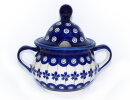 Conical sugar box with hole for a sugar-spoon in the...