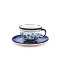 Coffee cup with curved out edge and saucer in the decor...