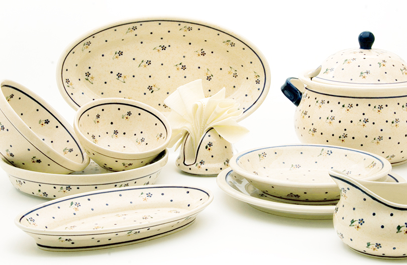 Bowls and bowls are on serving platters. A napkin holder is placed next to it.