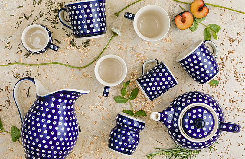 A ceramic pitcher lies next to a deep blue teapot. Mug and cup were provided.